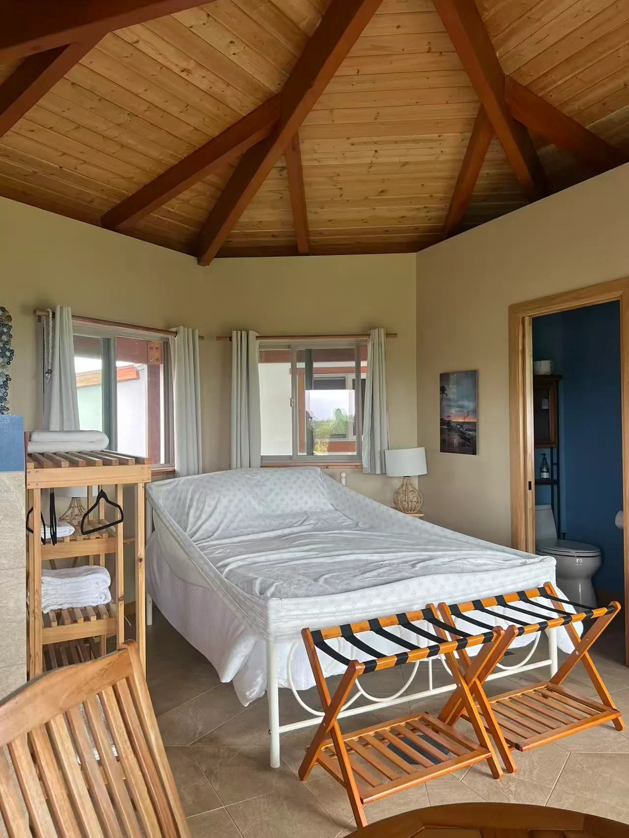 Bedroom inside the Hilo Airbnb guest house with vaulted wood ceiling
