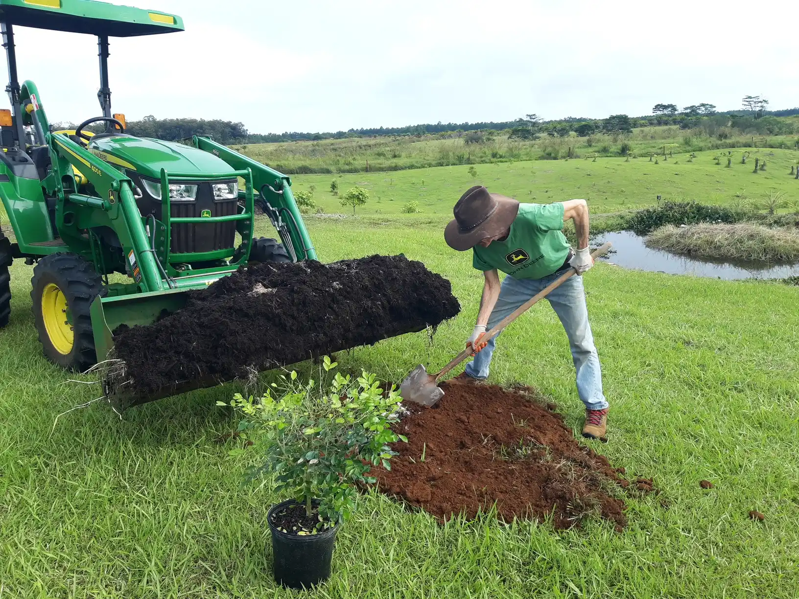 Mau planting a tree at Eco Village