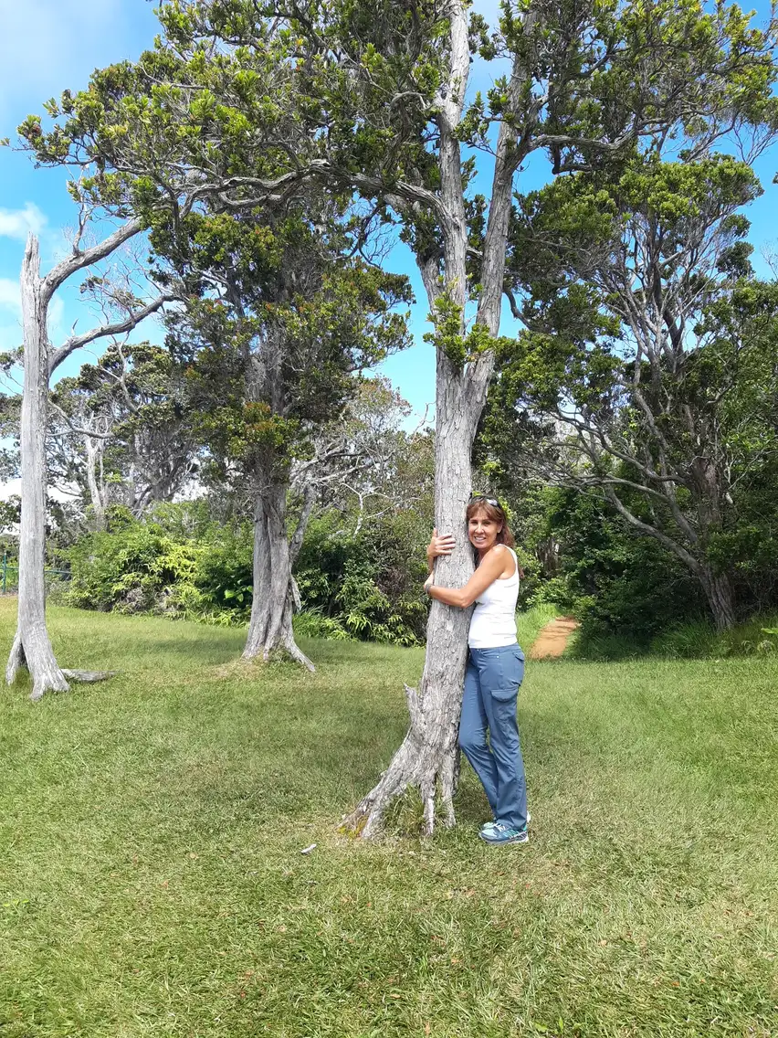 Paola hugging a young tree